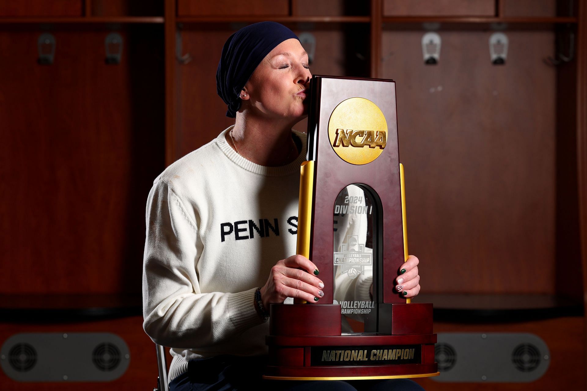 Katie Schumacher-Cawley with the Division I Women's Volleyball Championship trophy. (Photo via Getty Images)